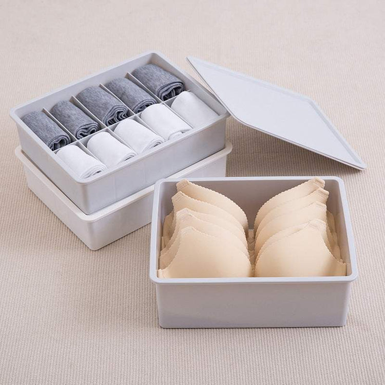 Drawer organizer tray in beige and gray modular sections for customizable storage in drawers