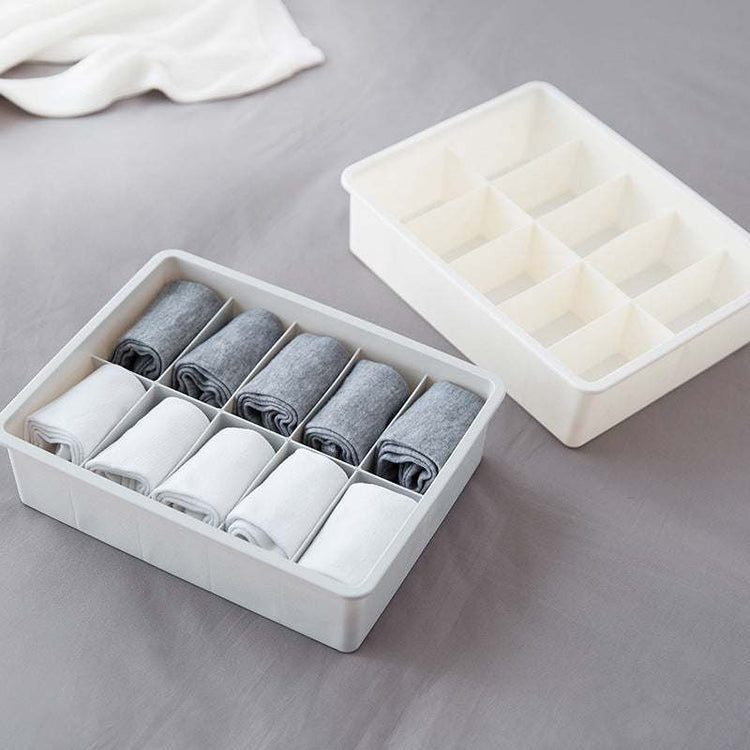 Drawer organizer tray made of durable polypropylene plastic in modular beige and gray sections for efficient storage and sorting