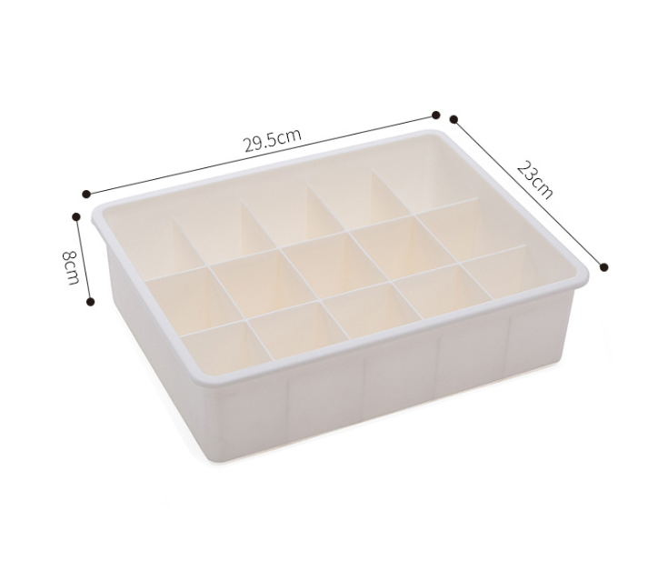 Drawer organizer tray in beige and gray modular sections for storage and sorting in drawers