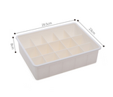 Drawer organizer tray in beige and gray modular sections for storage and sorting in drawers