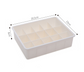 Drawer organizer tray in beige and gray modular sections for storage and sorting in drawers