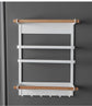 Magnetic kitchen towel rack and storage organizer mounted on refrigerator holding paper towels and spices