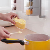 Wall-mounted Creative Multi-Functional Kitchen Seasoning Box with multiple tiers holding spice jars and condiment bottles in a modern kitchen setting